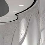 Die lackierte Oberfläche der mäandernden Innenwand im Konzertsaal. Der spannende Wechsel aus glatten Flächen sowie hervorspringenden Segmenten mit der einzigartigen Amöbenstruktur prägt das Raumdesign.