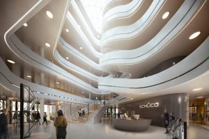 Das dynamische, über sämtliche Ebenen gestaltete Atrium ist architektonisches Highlight und zentraler Sammelpunkt des Gebäudes. Das Raumkonzept des Neubaus sieht eine offene kommunikationsfördernde Arbeitslandschaft vor, um den Dialog und Wissensaustausch